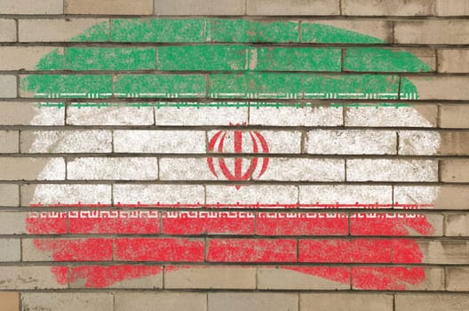 Chalky iranian flag painted with color chalk on grunge old brick wall