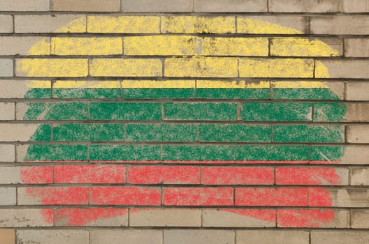 Chalky lithuanian flag painted with color chalk on grunge old brick wall