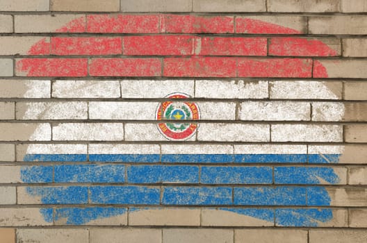 Chalky paraguay flag painted with color chalk on grunge old brick wall