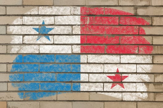 Chalky panama flag painted with color chalk on grunge old brick wall