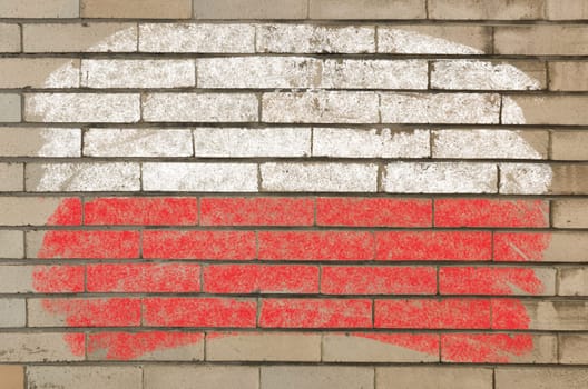 Chalky polish flag painted with color chalk on grunge old brick wall