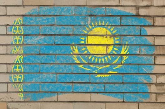 Chalky kazakstan flag painted with color chalk on grunge old brick wall