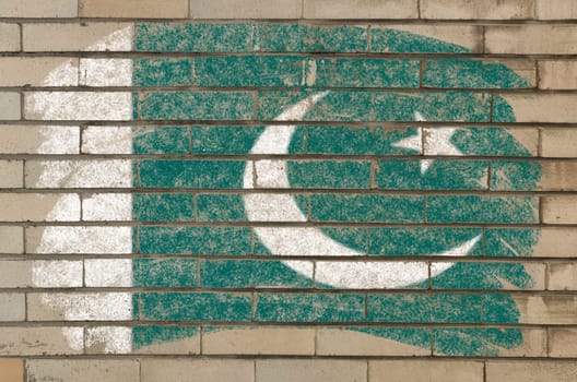 Chalky pakistan flag painted with color chalk on grunge old brick wall