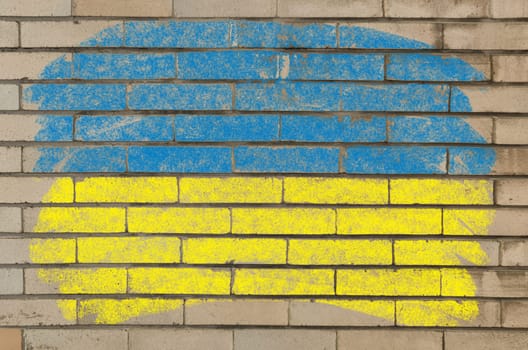 Chalky ukrainian flag painted with color chalk on grunge old brick wall