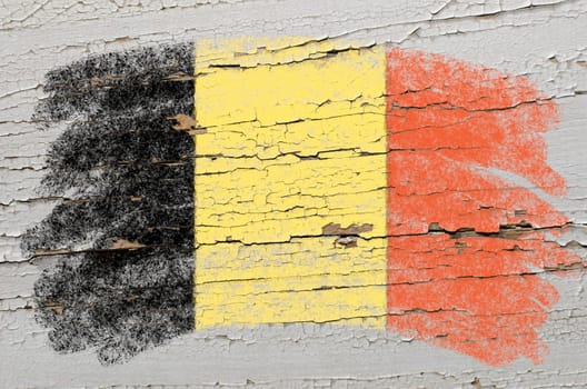 Chalky belgian flag painted with color chalk on grunge wooden texture