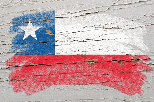 Chalky chile flag painted with color chalk on grunge wooden texture