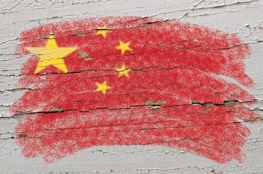 Chalky chinese flag painted with color chalk on grunge wooden texture