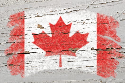 Chalky canadian flag painted with color chalk on grunge wooden texture