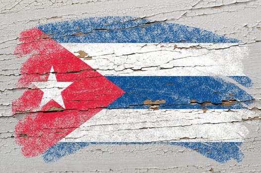 Chalky cuban flag painted with color chalk on grunge wooden texture