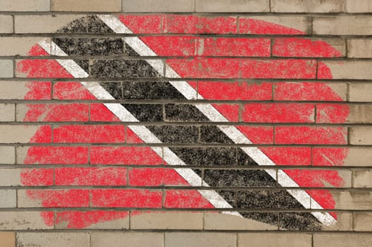 Chalky trinidad and tobago flag painted with color chalk on grunge old brick wall