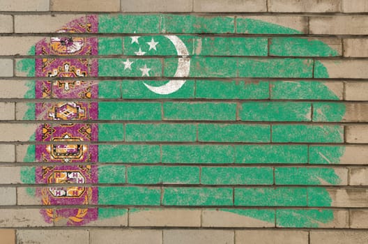 Chalky turkmenistan flag painted with color chalk on grunge old brick wall