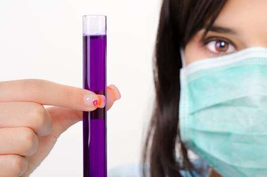 Close-up of glass tube with fluid in chemist hand