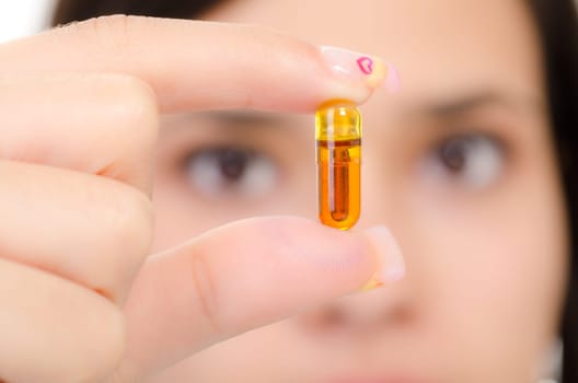 Brown pill in a woman&#039 s hand