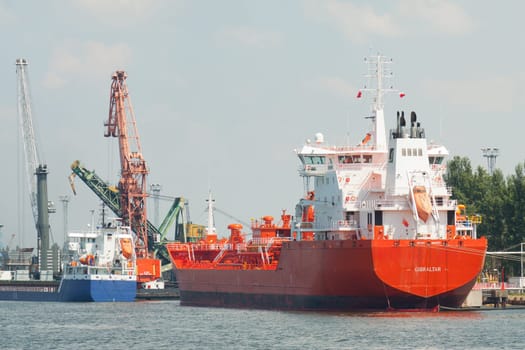 Red cargo ship in the industrial port of Świnoujście