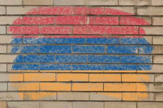 Chalky armenian flag painted with color chalk on grunge old brick wall