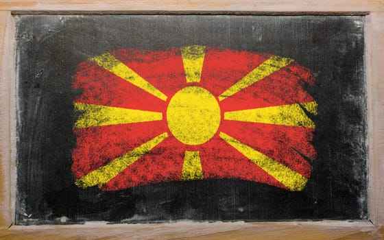 Chalky macedonian flag painted with color chalk on old blackboard