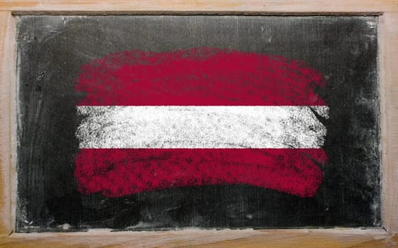 Chalky latvian flag painted with color chalk on old blackboard