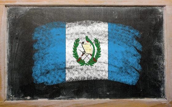 Chalky guatemalan flag painted with color chalk on old blackboard