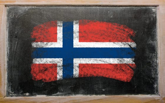 Chalky norwegian flag painted with color chalk on old blackboard