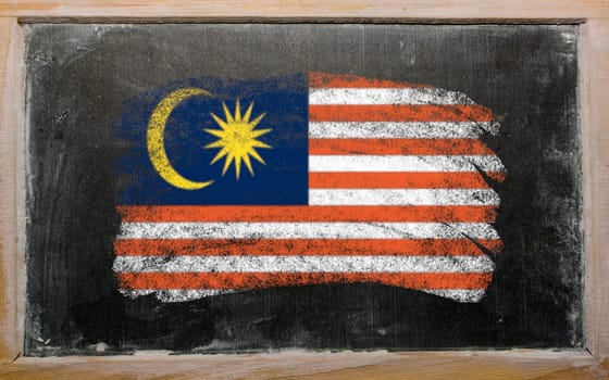 Chalky malaysian flag painted with color chalk on old blackboard
