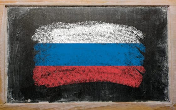 Chalky russian flag painted with color chalk on old blackboard