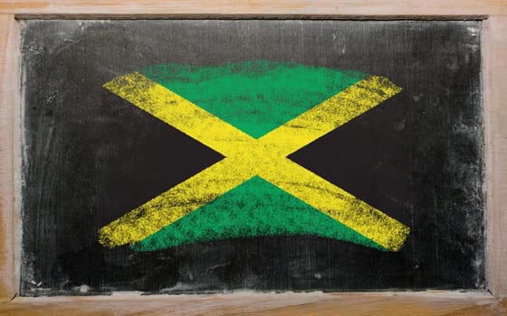 Chalky jamaican flag painted with color chalk on old blackboard