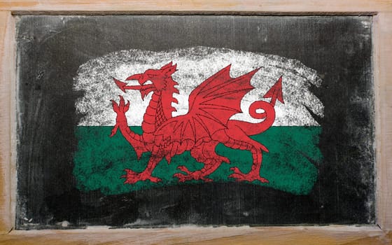 Chalky welsh flag painted with color chalk on old blackboard