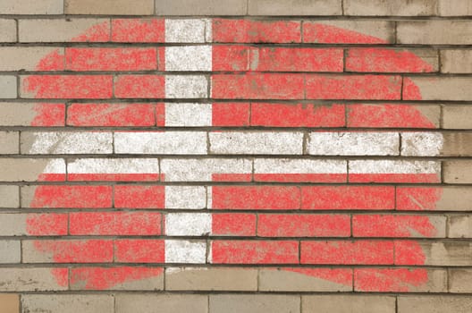 Chalky danish flag painted with color chalk on grunge old brick wall