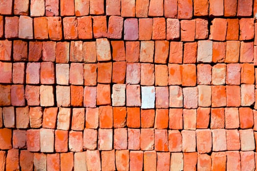 red stapled bricks give a harmonic pattern in the sun