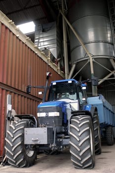 The harvest of colza with machines like a reaping-machine threshing-machine and tractor