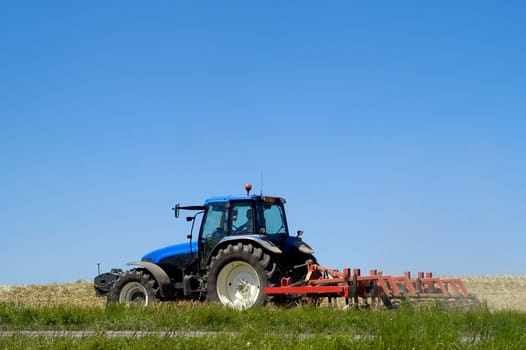 The harvest of colza with machines like a reaping-machine threshing-machine and tractor