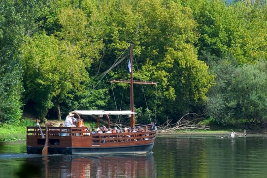 A walk in boat on the Dordogne on board traditional boatscalled barges or gabarres
