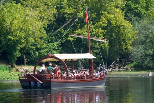A walk in boat on the Dordogne on board traditional boatscalled barges or gabarres