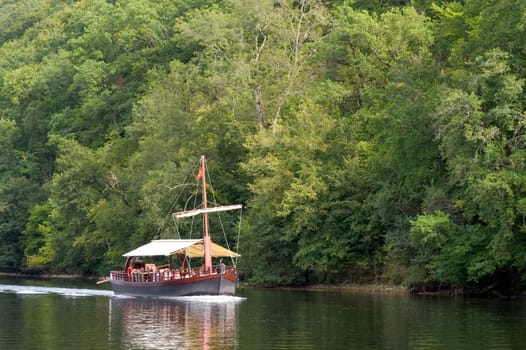 A walk in boat on the Dordogne on board traditional boatscalled barges or gabarres