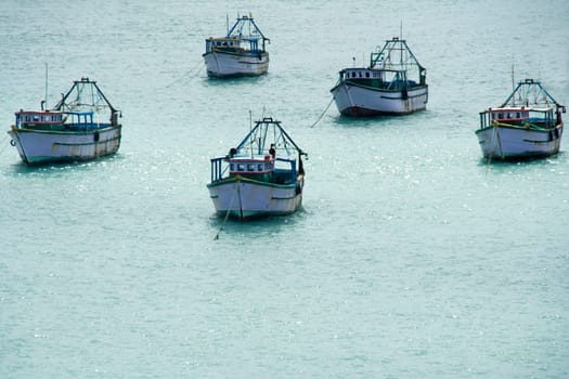 Convoy of five ships afloat on sea water
