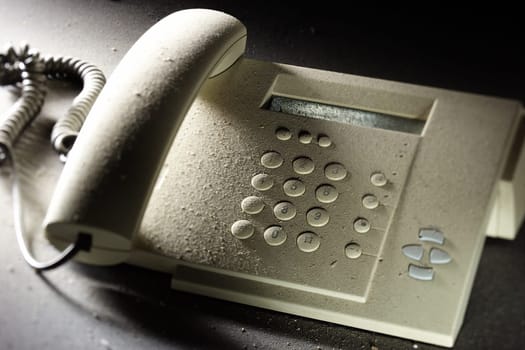Dusty,outdated telephone with a hang-up receiver