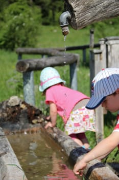 Children playing with water in nature