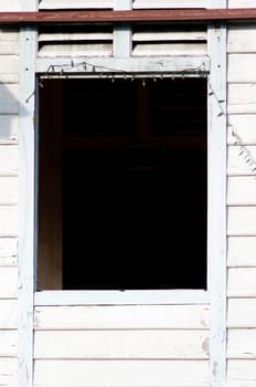 a window of a abandoned wooden house.