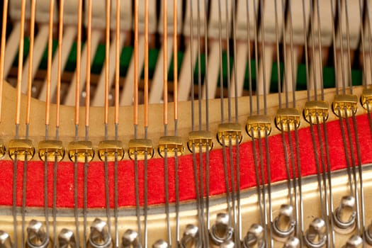 Close up image of interior of grand piano showing strings and structure