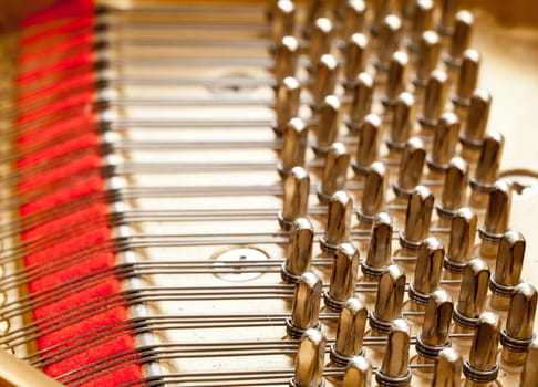 Close up image of interior of grand piano showing strings and structure