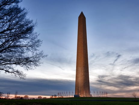Washington Monument in DC at dusk as the sun is setting and tower is illuminated