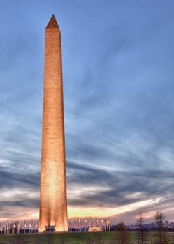 Washington Monument in DC at dusk as the sun is setting and tower is illuminated