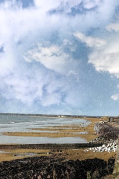 beach during a rain storm on the rocks in youghal county cork ireland
