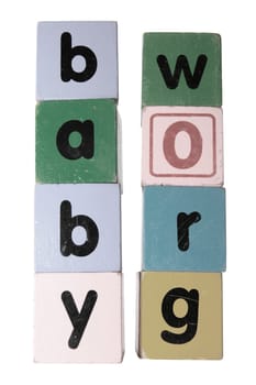 assorted childrens toy letter building blocks against a white background that spell baby grow with clipping path