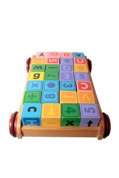 childrens toy letter building blocks all together in a toy cart isolated on white background with clipping path