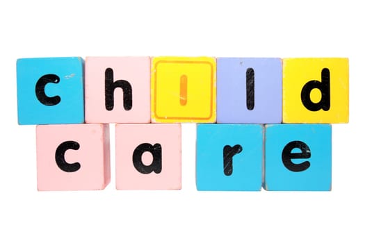 assorted childrens toy letter building blocks against a white background that spell childcare with clipping path