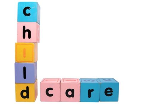 assorted childrens toy letter building blocks against a white background that spell childcare with clipping path