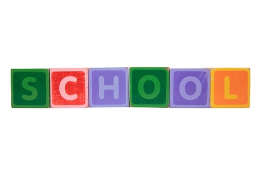 assorted childrens toy letter building blocks against a white background that spell school with clipping path