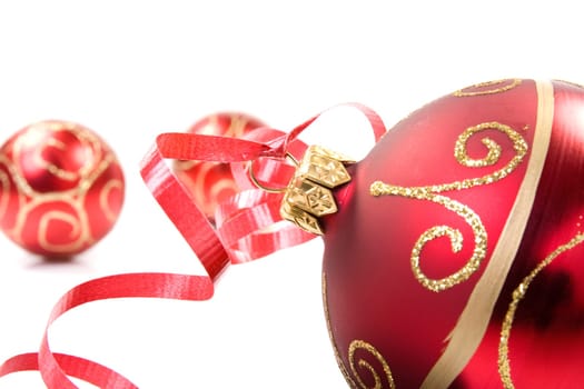 red christmas baubles over a white background