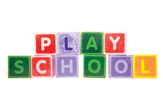 assorted childrens toy letter building blocks against a white background that spell playschool with clipping path